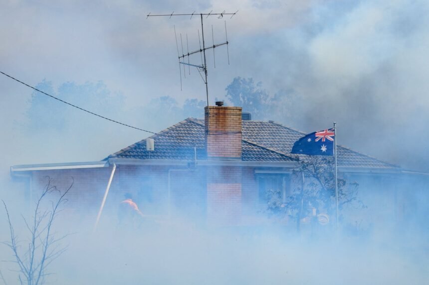 Country-Fire-Authority-CFA-members-douse-a-home-in-Longwood-VIC-bdhf14ep