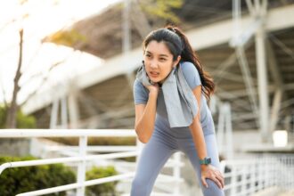 A-woman-wiping-sweat-from-her-neck-after-a-run