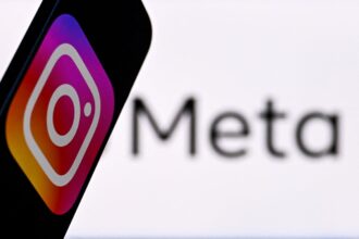 Social-network-Instagram-logo-displayed-on-a-smartphone-in-front-of-the-media-giant-Metas-logo