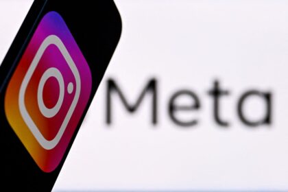 Social-network-Instagram-logo-displayed-on-a-smartphone-in-front-of-the-media-giant-Metas-logo